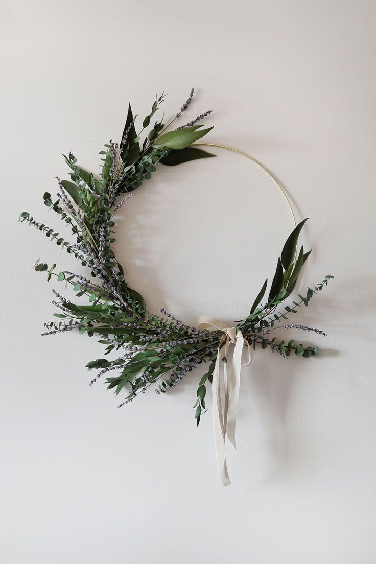 a wreath with greenery tied around it