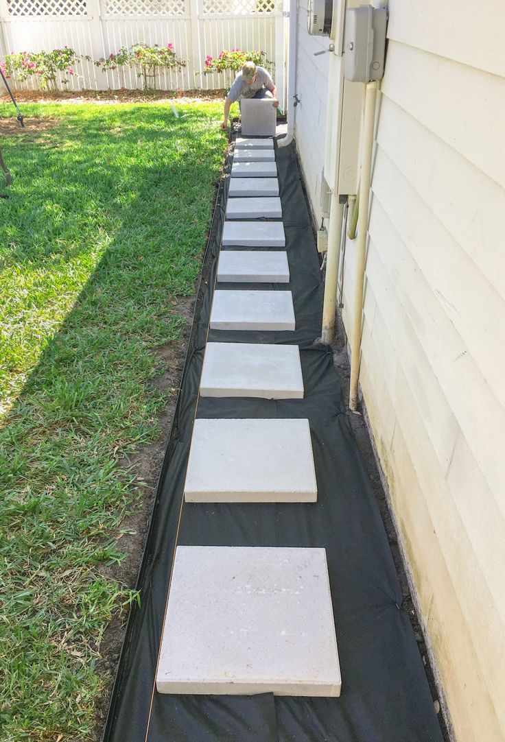 a long row of stepping stones in front of a house