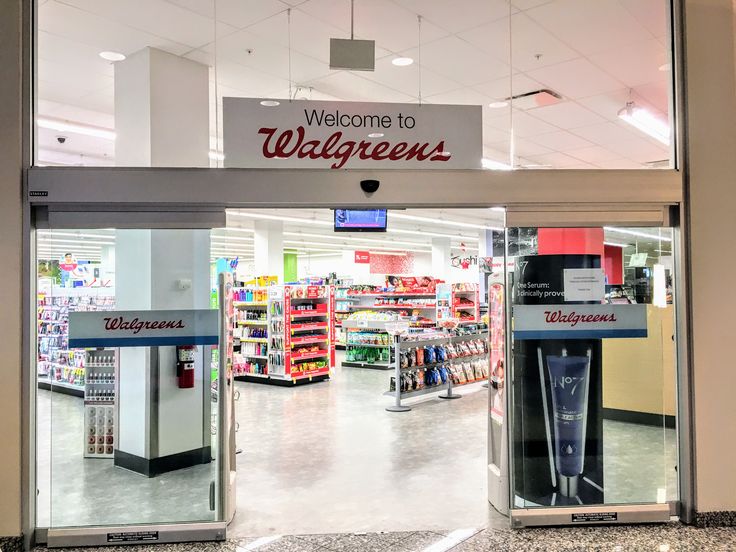 the front entrance to walgreens store with its glass doors open and there is a sign that says welcome to walgreens