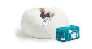 a woman sitting in a bean bag chair next to a blue tissue box on the floor