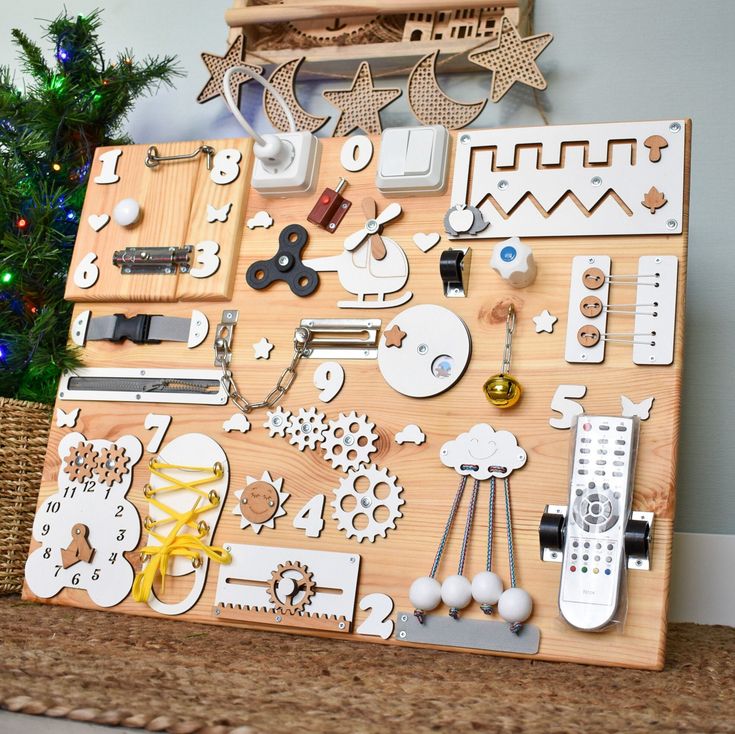 a wooden board with various items on it and a christmas tree in the back ground