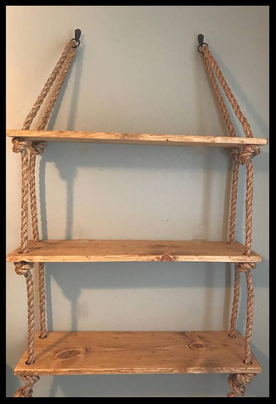 two wooden shelves with rope hanging from the top, and one shelf on the bottom