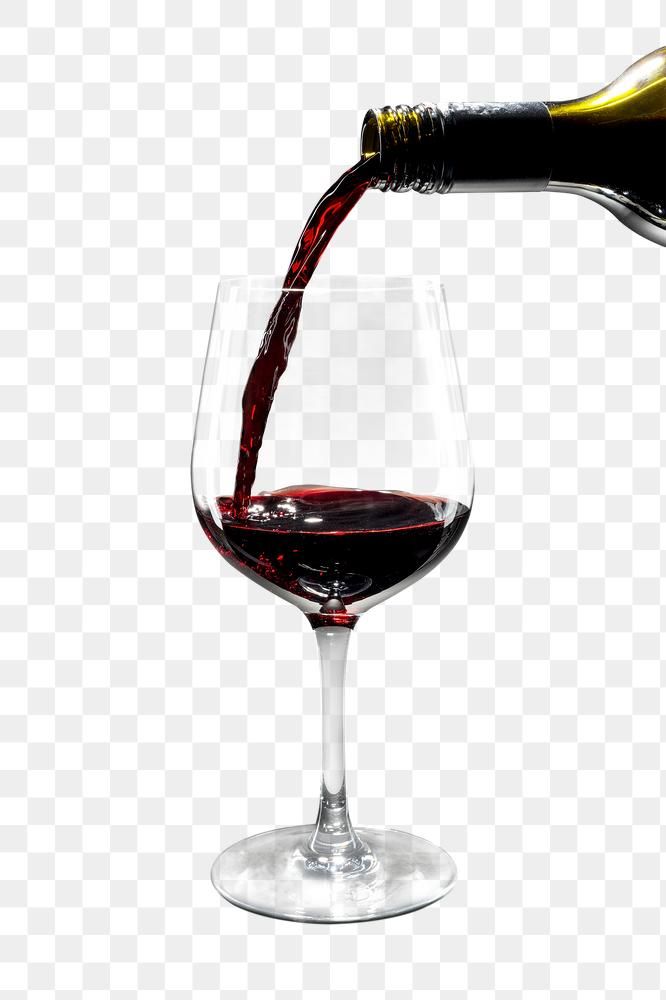 a wine glass filled with red wine being poured into it, on a white background