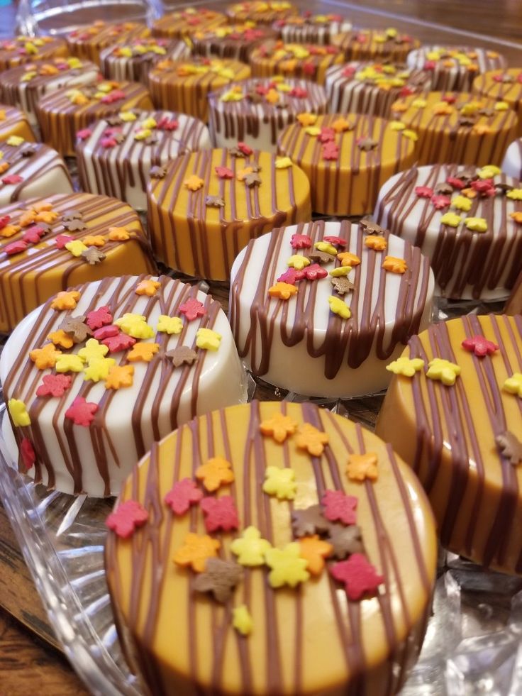 chocolate covered desserts are on display in a glass case