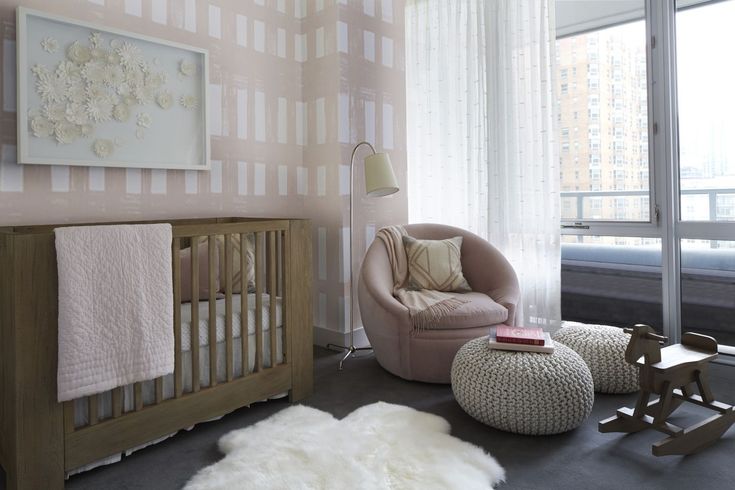 a baby's room with pink and white decor