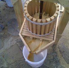 a bucket filled with liquid sitting on top of a wooden structure