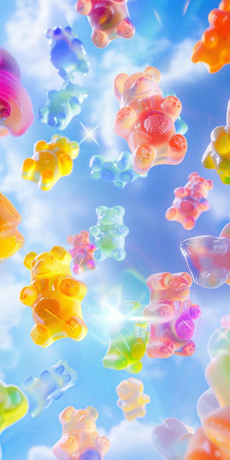 many gummy bears are floating in the air with blue sky and clouds behind them