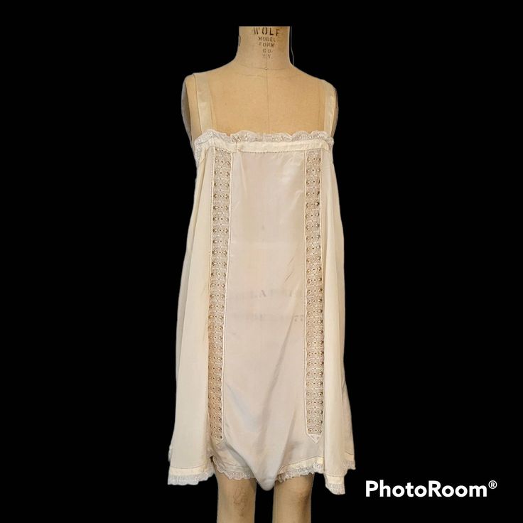 "Lovely 1920s lingerie. This one a larger size. Pretty antique underpinnings. Silk and bobbin lace insets with pale blue embroidery on the side of each leg \"wing\". There's a drawstring ribbon inside of the top of the bodice, and ribbon straps. No issues. Clean and ready to wear. Measures just to 20 inches along the the front of the top of the bodice (top of the bust) which can be adjusted by (gently) ruching it along the ribbon tie. 23-ish inches across the front of the bust while flat (not to Vintage Delicate Lace Sleepwear, Teddy Lingerie, Bodice Top, Blue Embroidery, Lace Inset, Lace Embroidery, Ribbon Tie, Bobbin Lace, Pale Blue