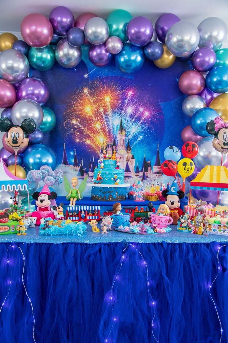 a birthday party with balloons and mickey mouse decorations