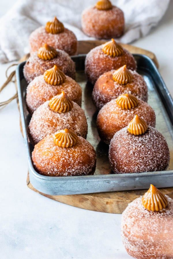 several pastries are on a tray with powdered sugar