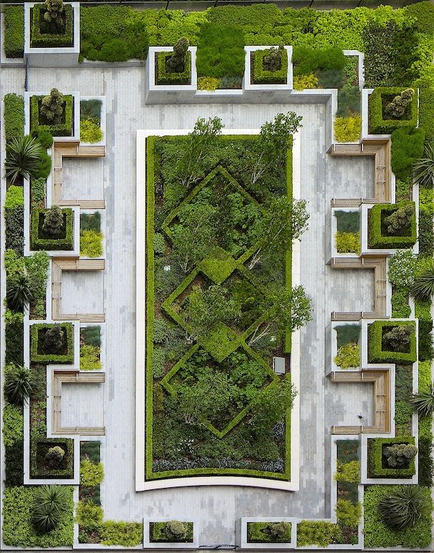 an aerial view of a garden with many trees and plants on it's sides