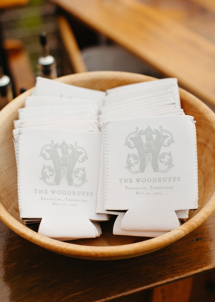 napkins are placed on top of each other in a wooden bowl at a wedding reception