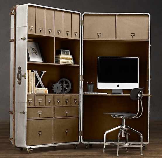 an old metal cabinet with a computer on top and some drawers in front of it