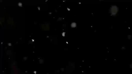 snow is falling down on the ground and it looks like they are in the dark