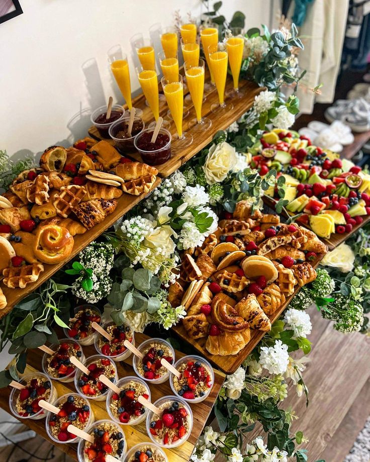 an assortment of desserts and drinks on display in a buffet style setting at a wedding