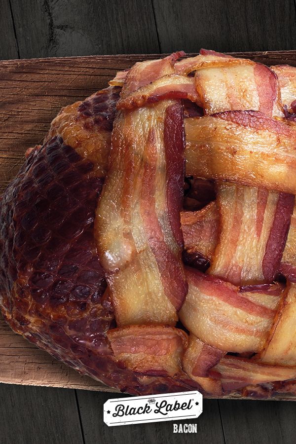 bacon wrapped in strips sitting on top of a cutting board