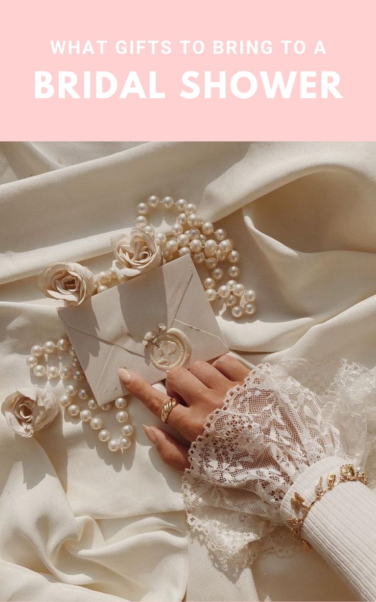 a woman's hand holding an envelope with pearls on it and the words what gifts to bring to a bridal shower