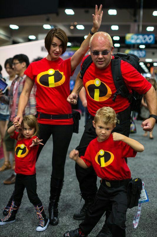 a group of people dressed in costumes at an event with one man and two children