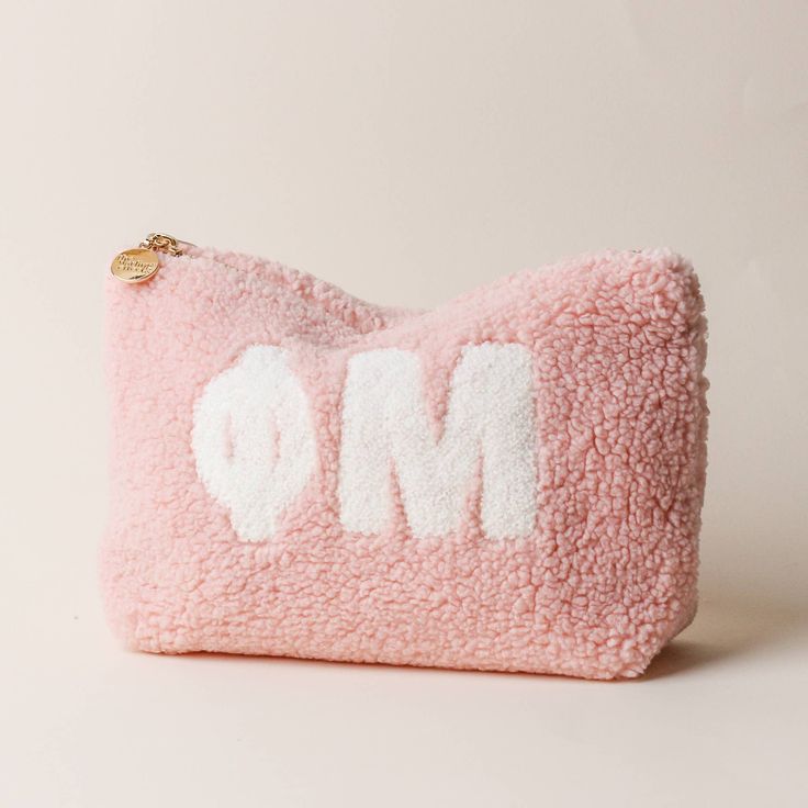 a pink purse with the word om written on it