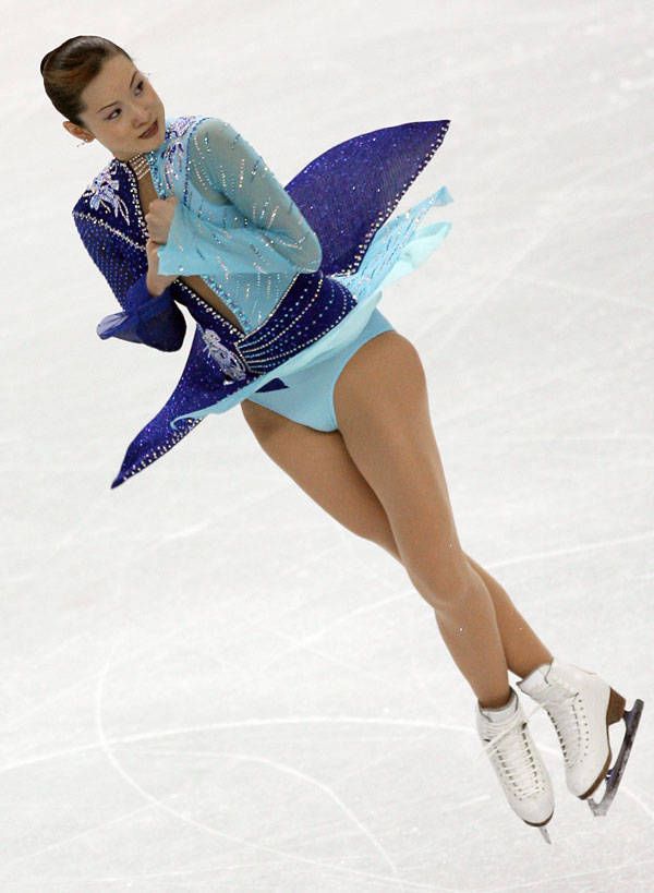 a female figure skating on an ice rink