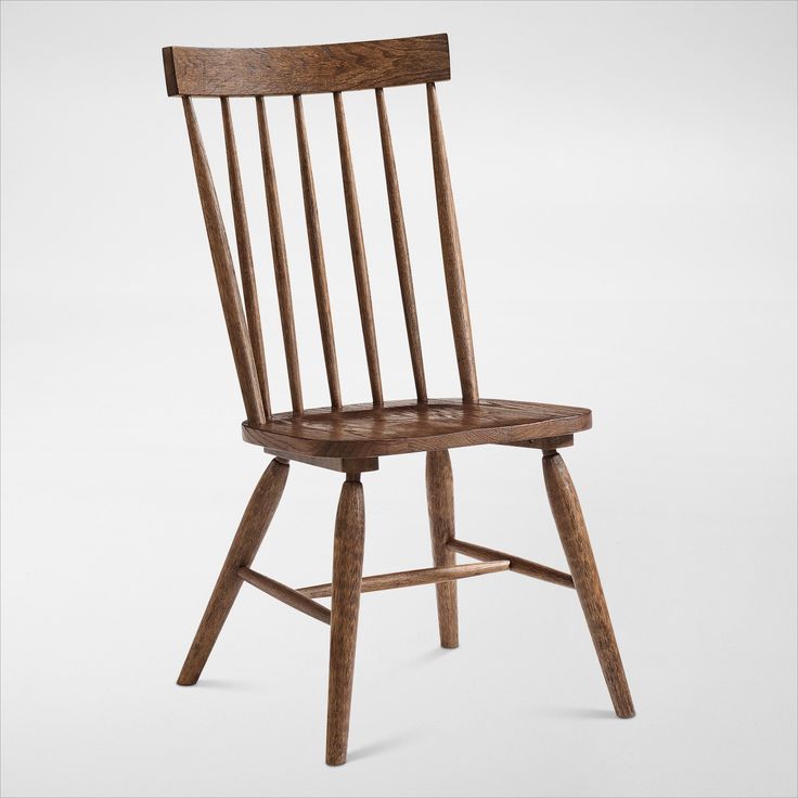 a wooden chair sitting on top of a white floor