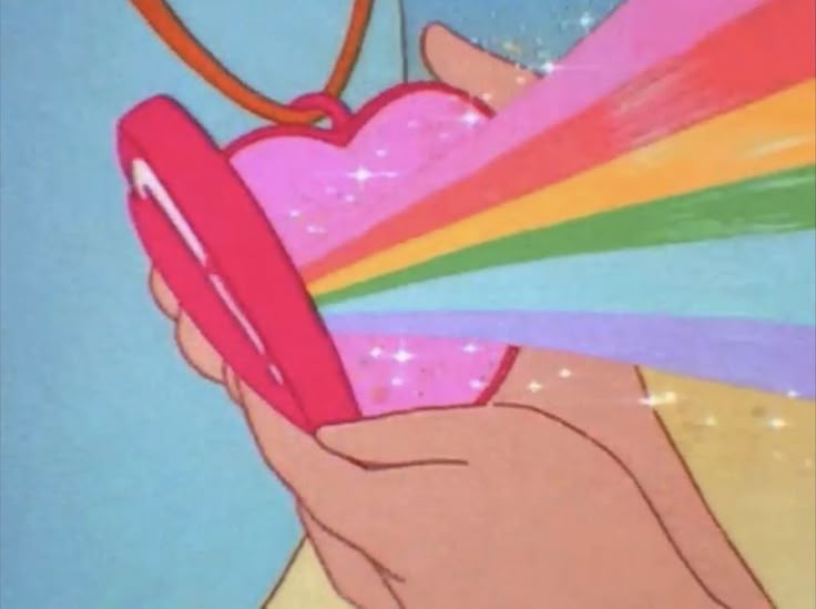 a hand holding a heart shaped object in front of a rainbow colored background with stars