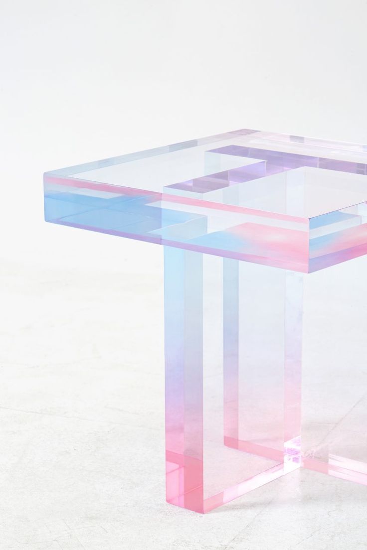 a pink and blue table sitting on top of a white floor