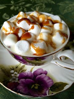 a cup filled with marshmallows on top of a saucer