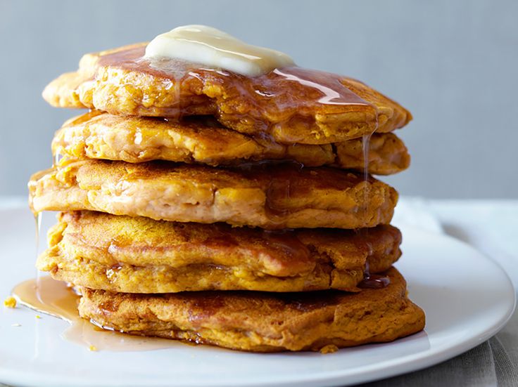 a stack of pancakes with syrup and butter on top