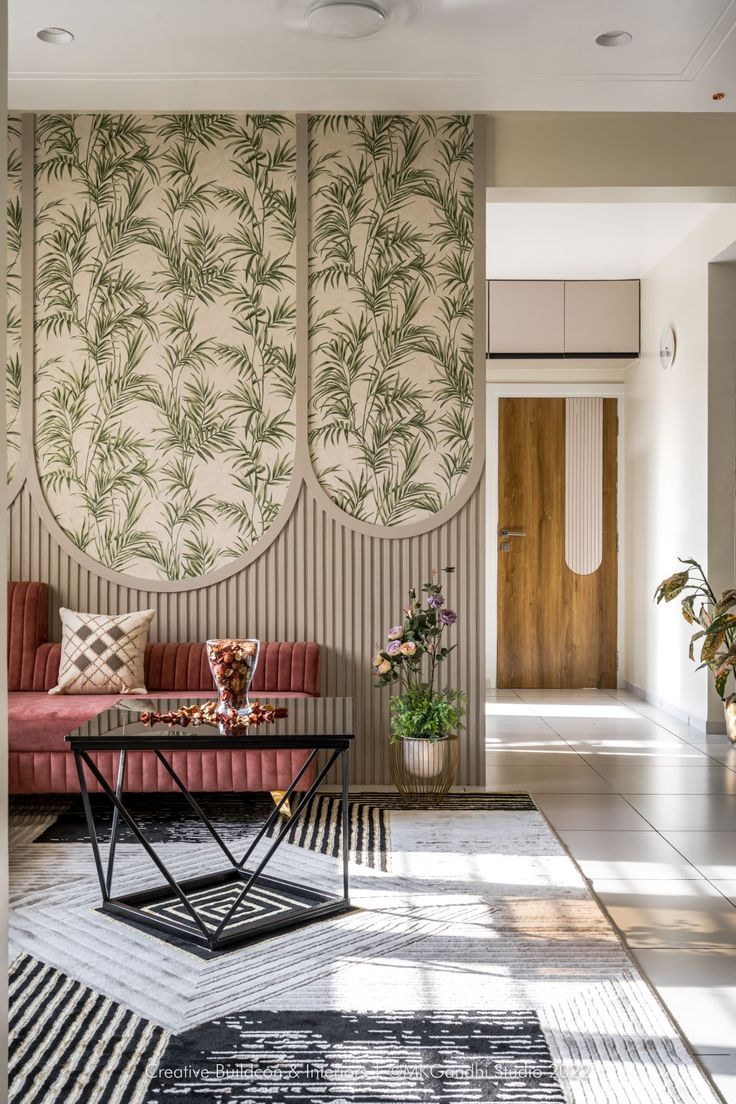 the living room is decorated with tropical wallpaper