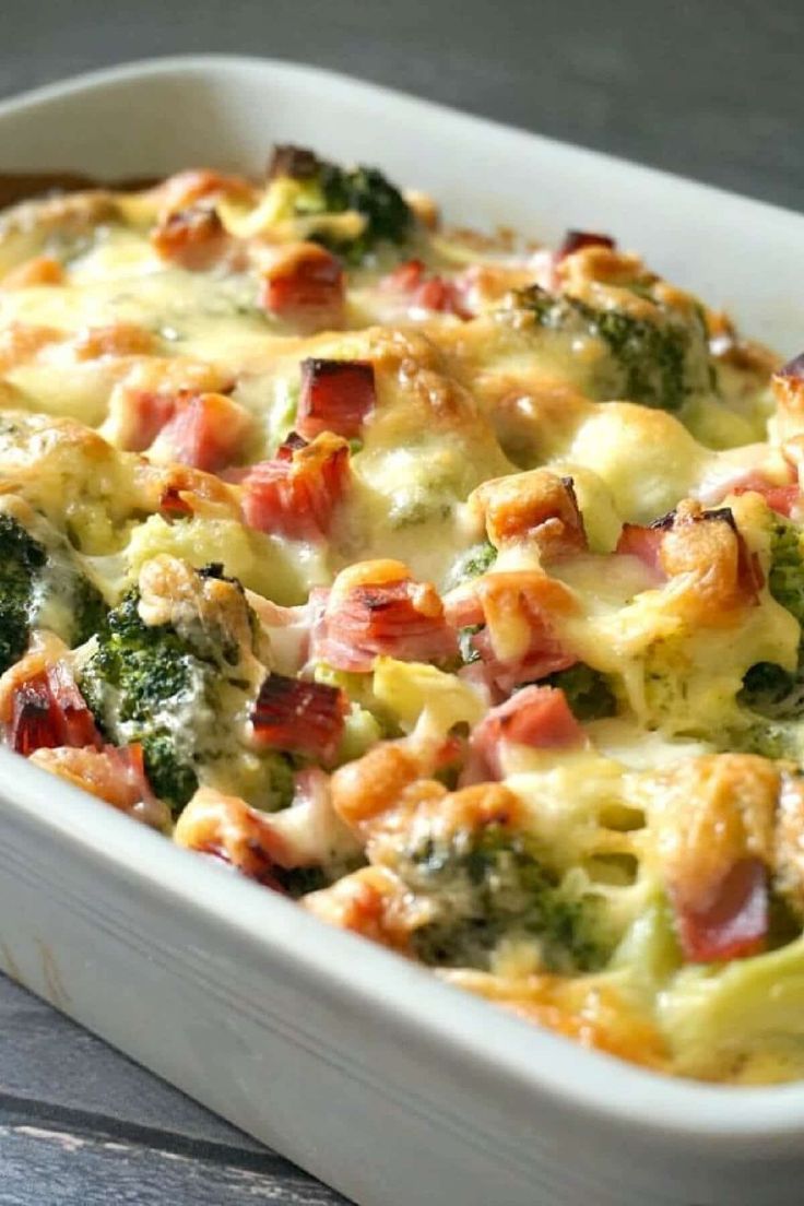 a casserole dish with broccoli, ham and cheese