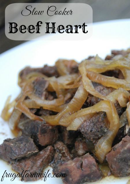 beef and onion stir fry on a white plate with the words slow cooker beef heart