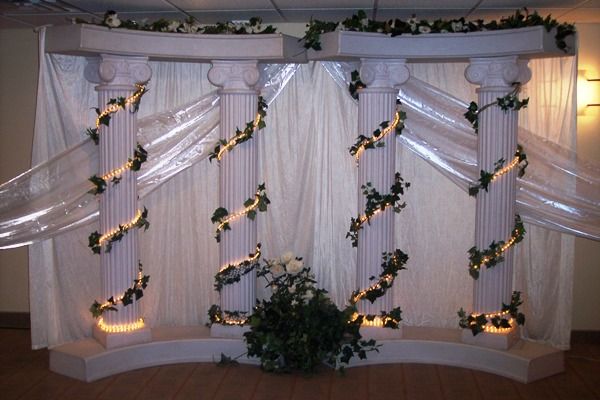 a room decorated with white curtains and string lights