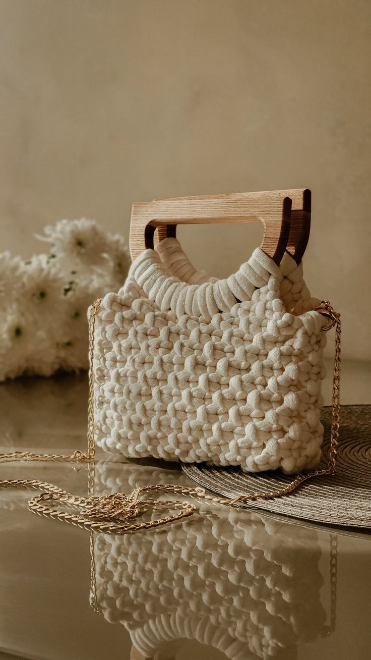 a white purse sitting on top of a table