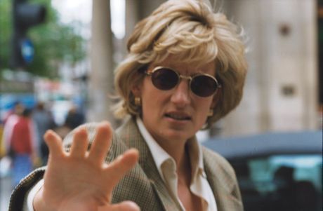 a woman wearing sunglasses making the vulcan sign