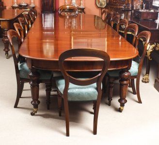 a large wooden dining table surrounded by blue chairs