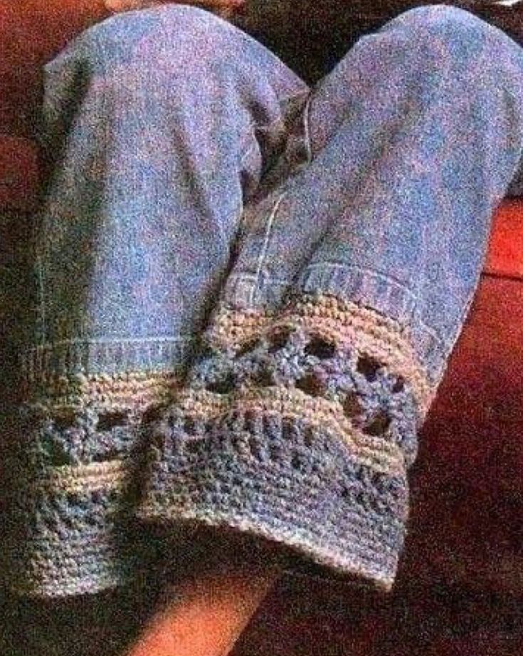 a person is sitting on a couch with their feet propped up and crocheted