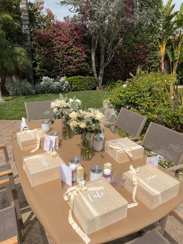 the table is set with boxes and flowers