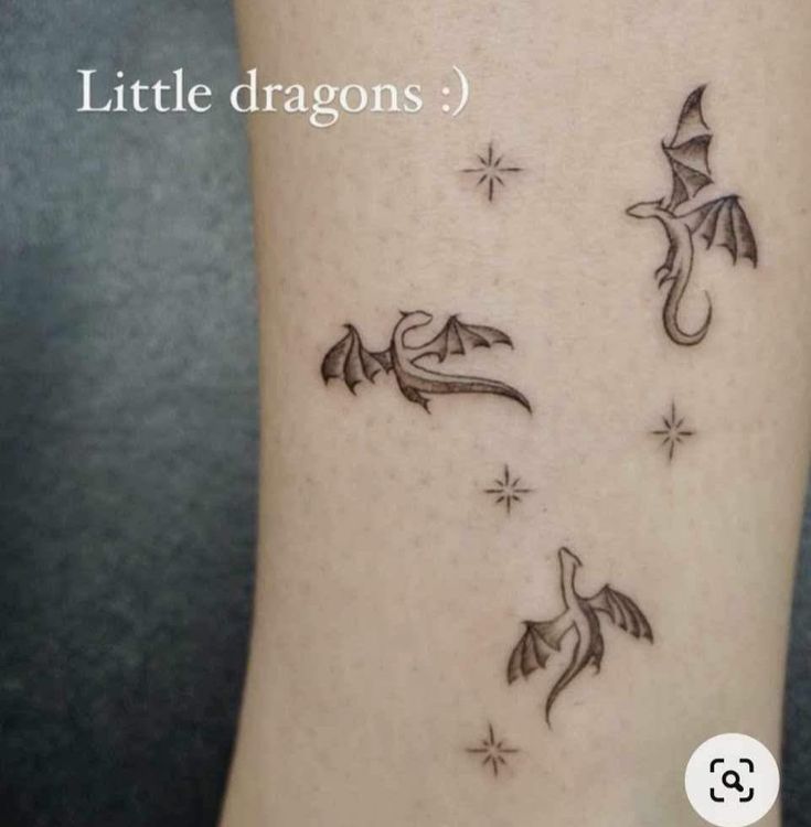 a small tattoo on the side of a woman's leg with little dragon designs