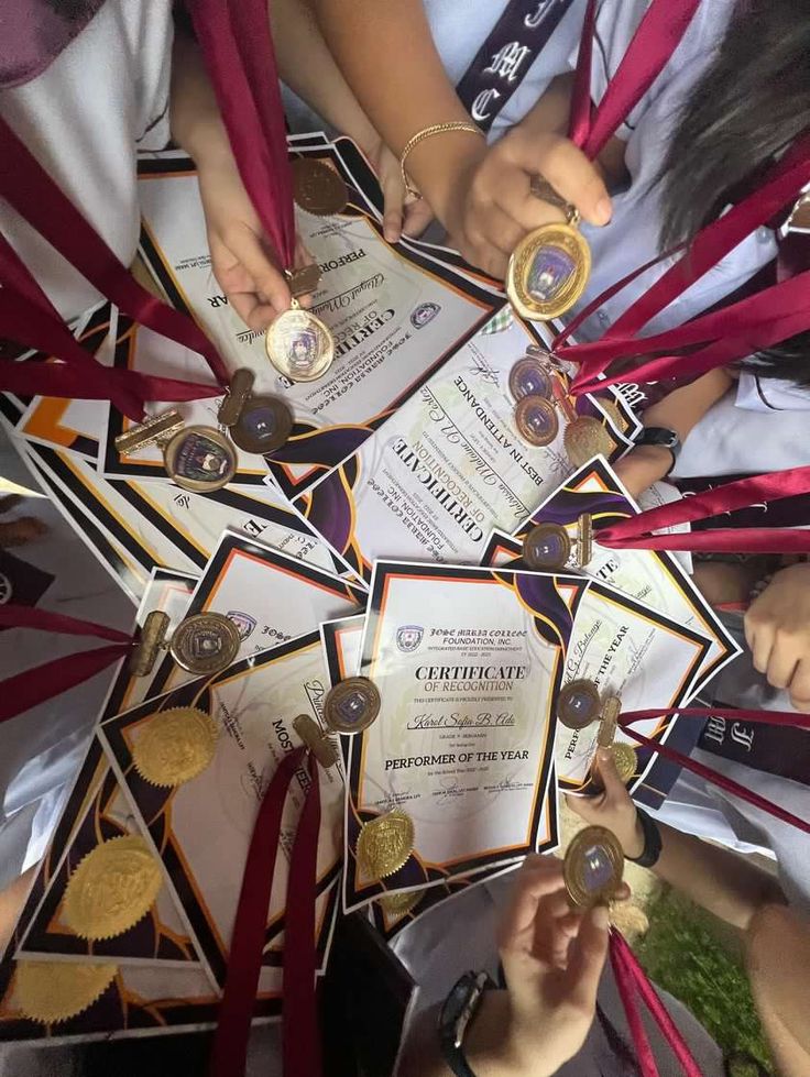 several people holding up their medals and ribbons