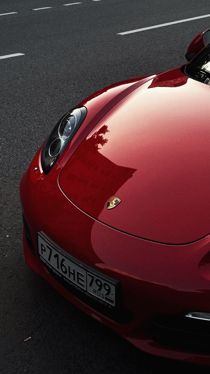 a red sports car is parked on the street