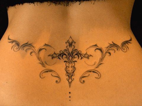 the back of a woman's stomach with an intricate design on her lower side