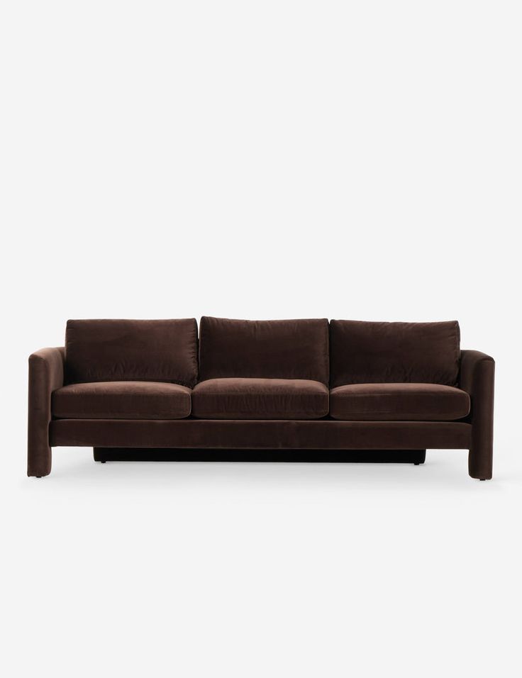 a brown couch sitting on top of a white floor