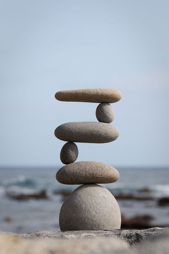 several rocks stacked on top of each other near the ocean