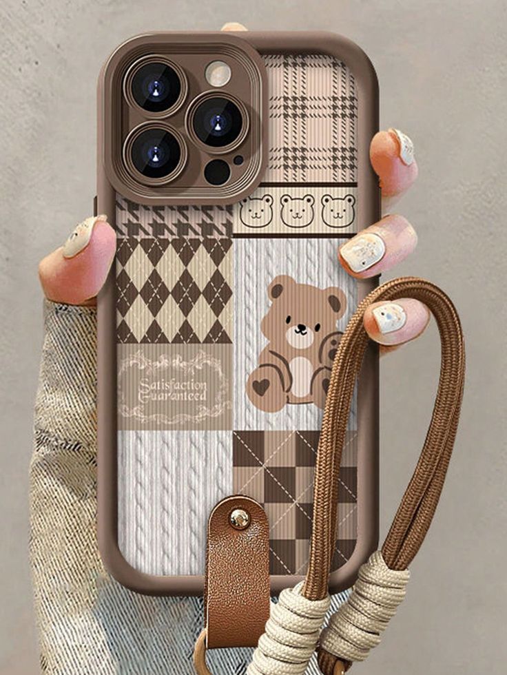 someone holding up their phone case with a teddy bear on the front and back cover