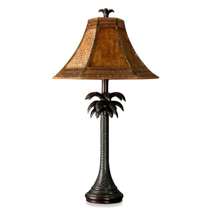 a lamp that is sitting on top of a table with a brown shade over it