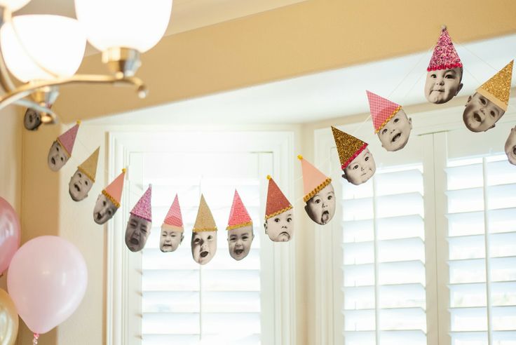 a birthday party with balloons and decorations in the shape of people's faces on them