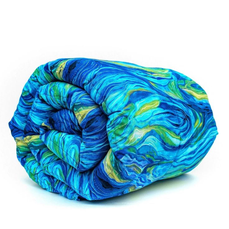 a blue and yellow blanket on top of a white surface