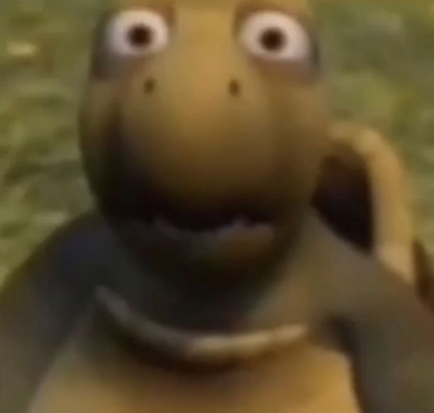 a close up of an animated turtle on the ground with grass in the background and eyes wide open