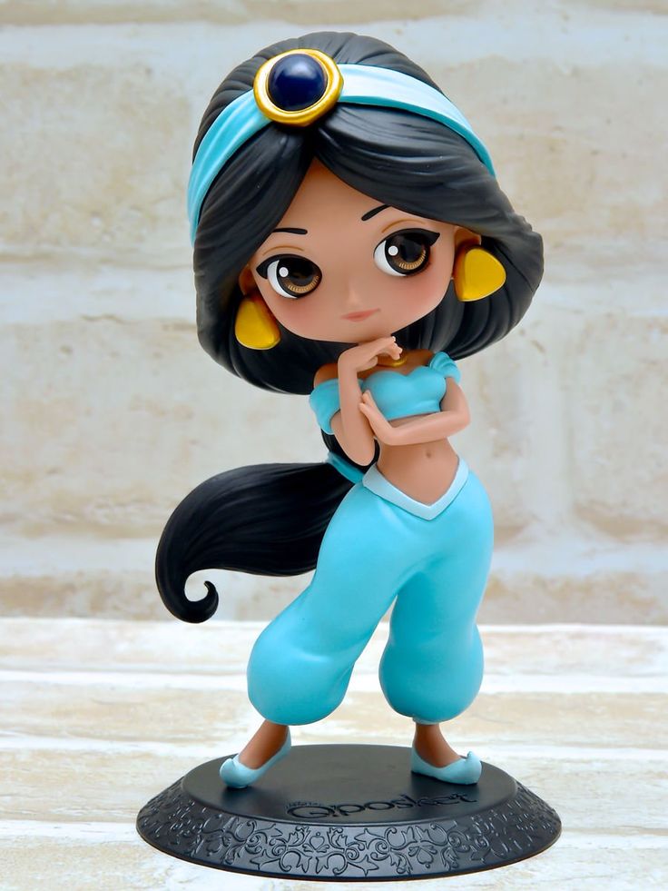 a figurine is shown on top of a base with a blue outfit and yellow earrings